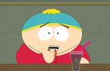 Cartman eating an onion ring.